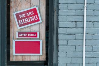 a sign that says we are hiring and apply today by Eric Prouzet courtesy of Unsplash.